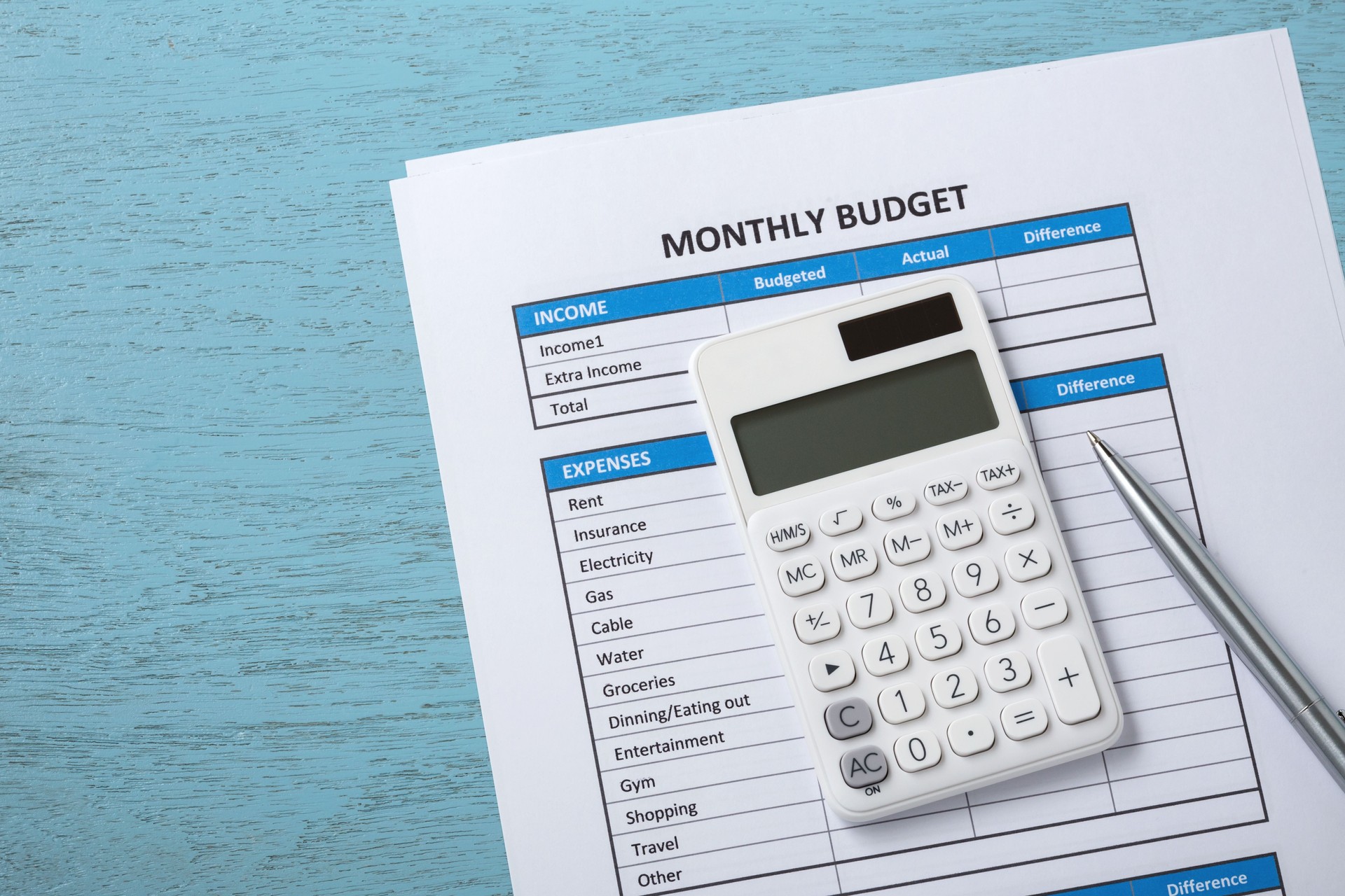 Monthly budget concept on blue wood desk background